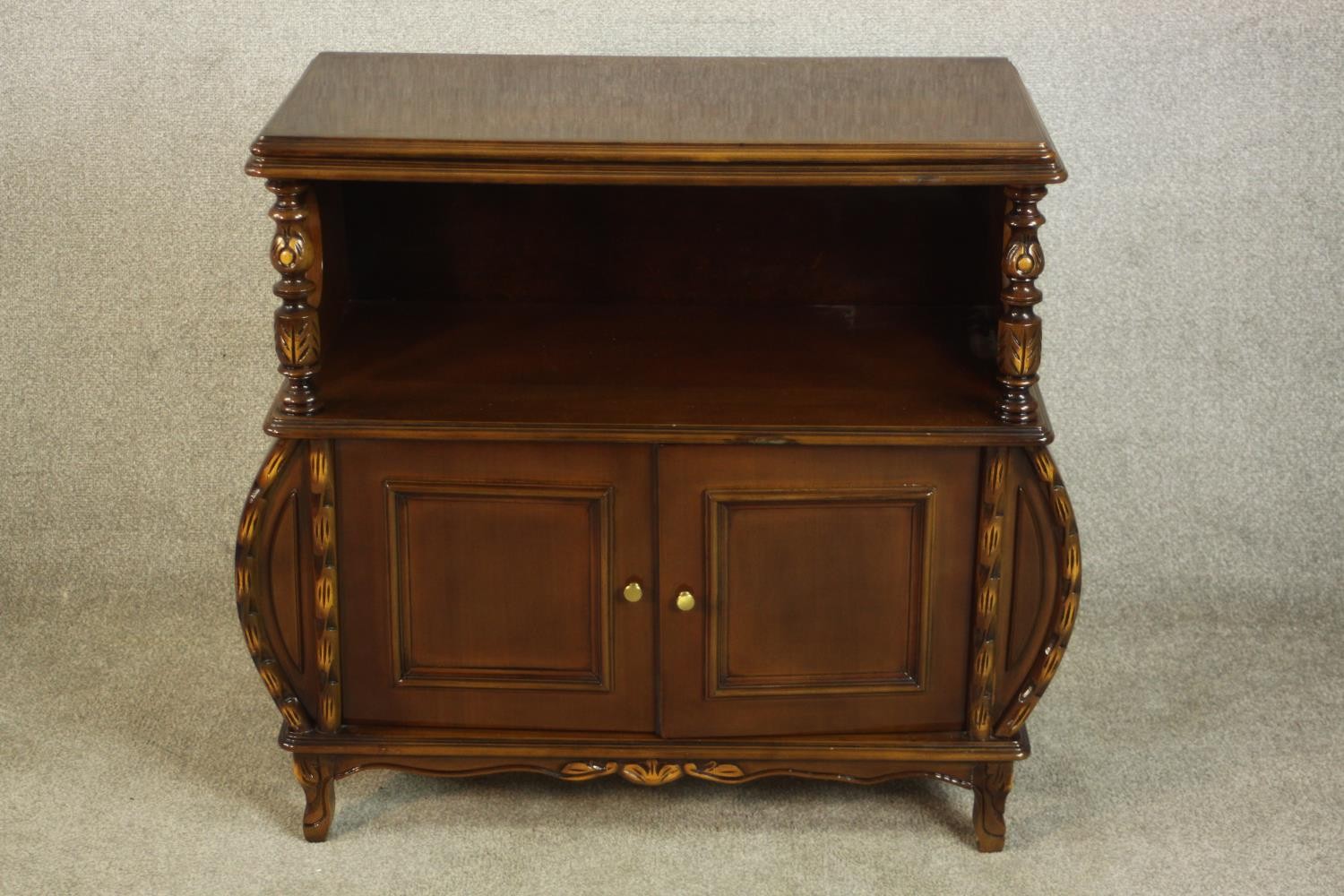 A late 20th century side cabinet, the rectangular top with a moulded edge supported by turned and