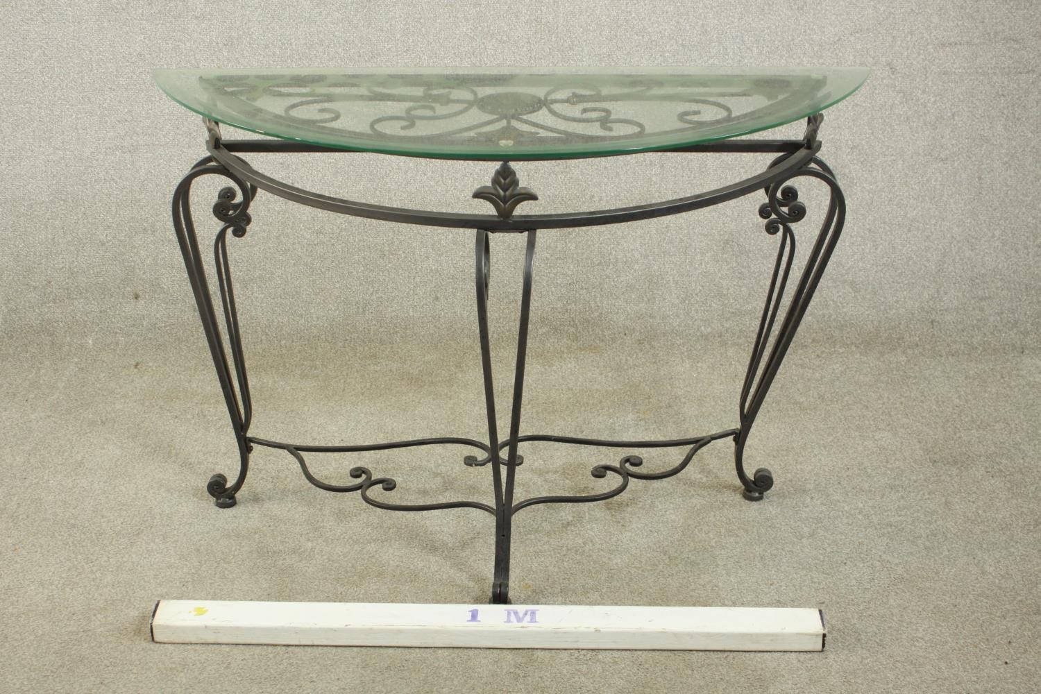 A contemporary wrought iron side table, of demi lune form with a plate glass top on three - Image 2 of 9