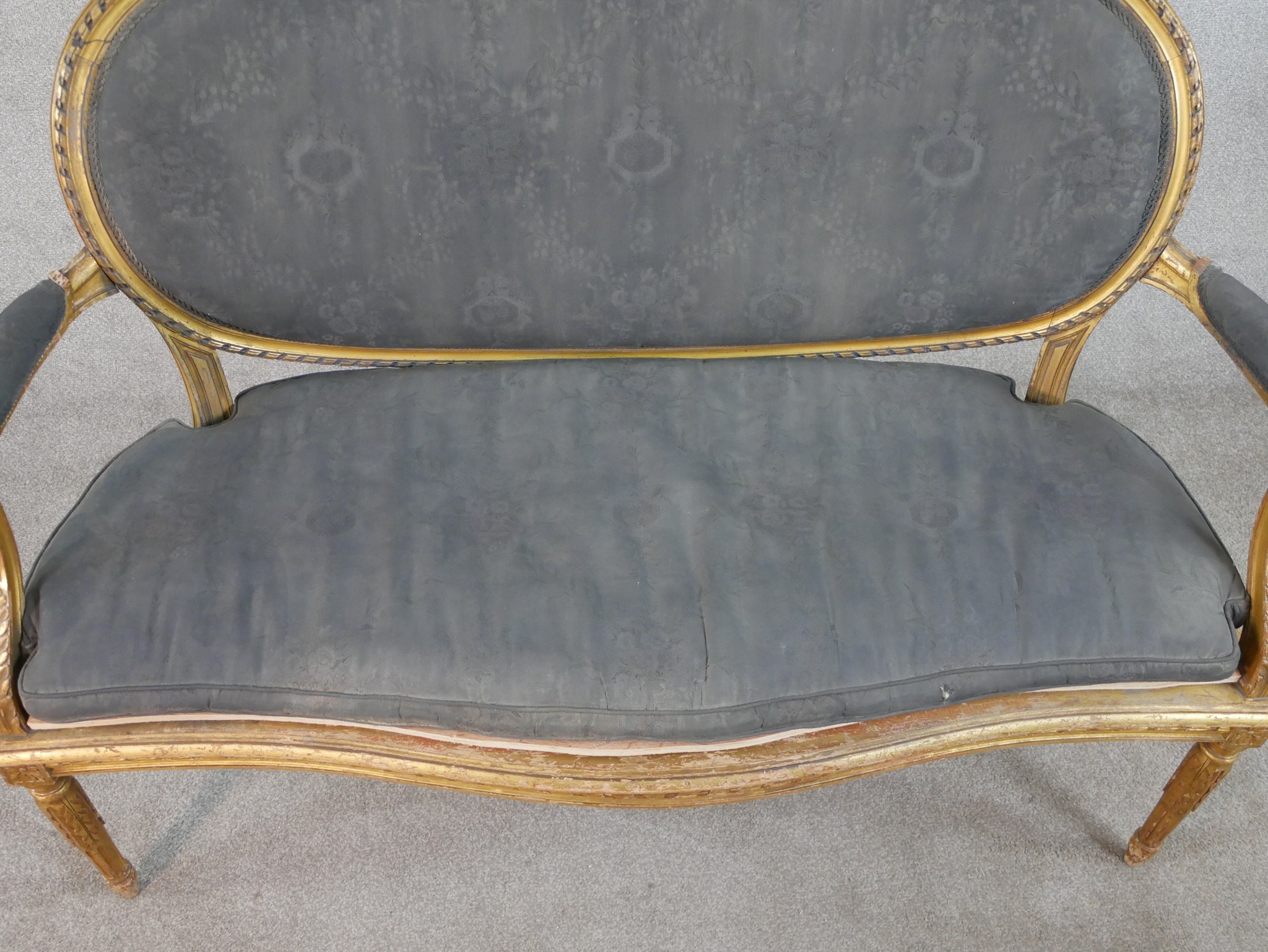 A French Louis XVI style carved giltwood canape, upholstered in grey fabric to the oval back, the - Image 2 of 6