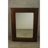 A contemporary rectangular mirror in a brown faux suede cushion frame. H.122 W.90cm