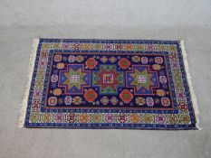 A blue ground hand made Russian Kazak rug. W.129 D.80cm