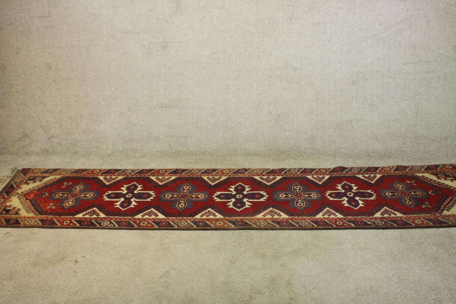 A hand made red ground Turkish Dosemealti runner. L.280 W.77cm