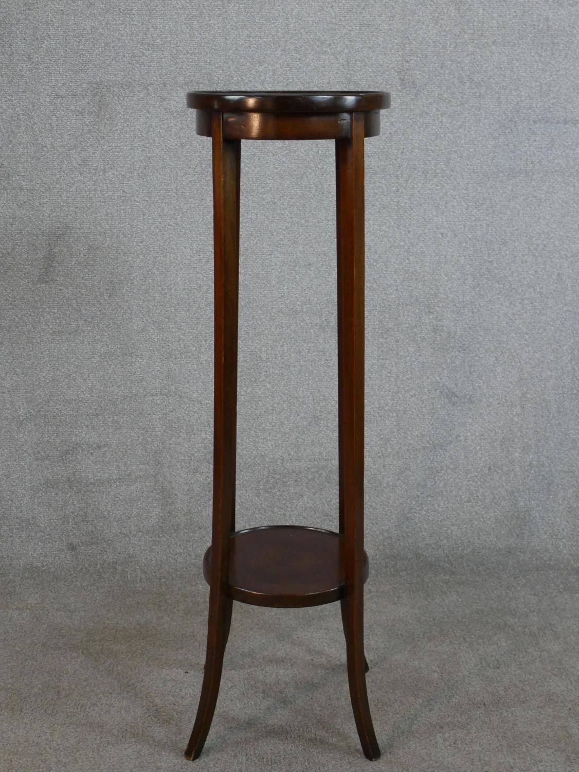 An Edwardian mahogany two tier circular jardinere stand H.99 Diam.29cm