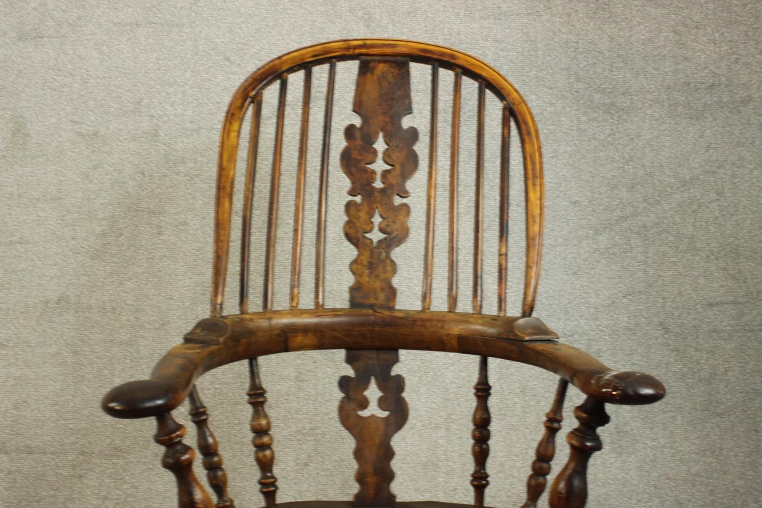 A 19th century Windsor armchair, with a yew hoop back and pierced splat over an elm seat, on - Image 5 of 7