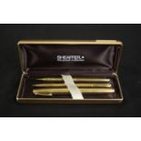 A cased set of vintage Schaefer rolled gold engraved linear design pens. Includes ball point pen,