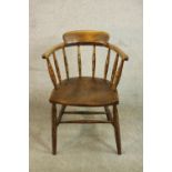 A 19th century captain's tub chair, the back on ring turned spindles, over an elm seat, on ring