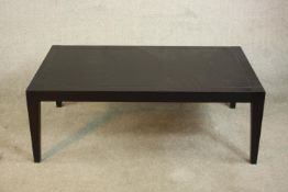 A contemporary black ash coffee table, of rectangular form with tapering legs. H.43 W.120 D.70cm