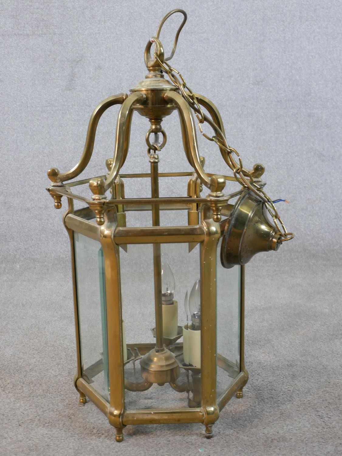 A 20th century brass framed and bevelled glass hexagonal hall lantern. H.56 W.37 D.37cm