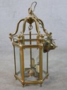 A 20th century brass framed and bevelled glass hexagonal hall lantern. H.56 W.37 D.37cm
