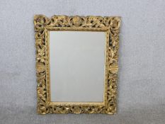 A 19th century Italian Florentine carved giltwood and gesso framed mirror, of rectangular form,