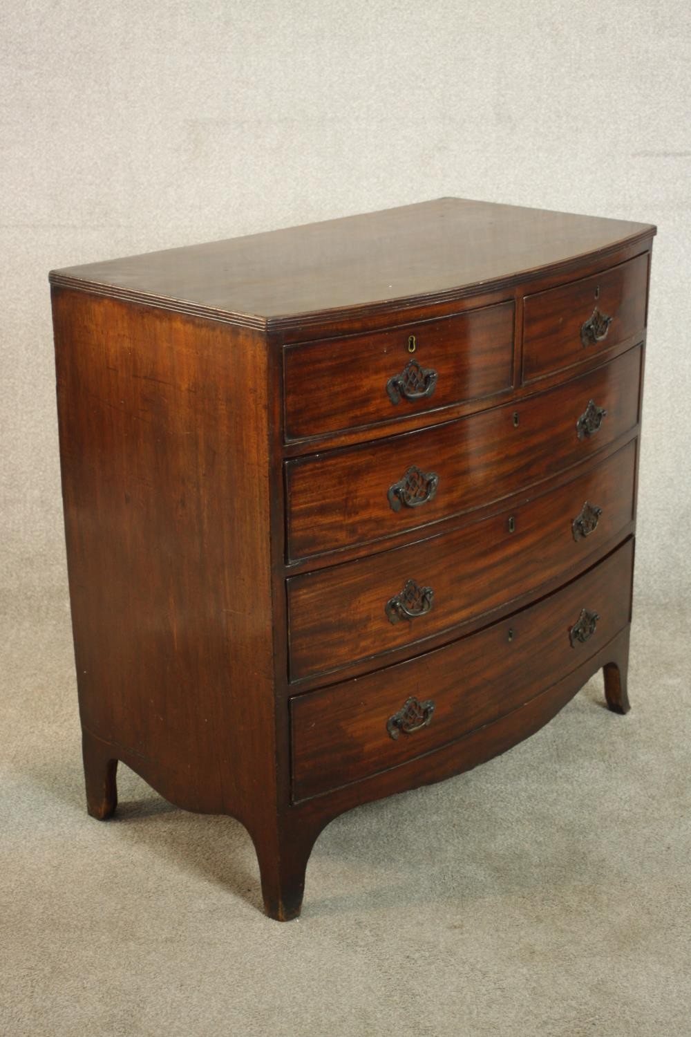 A George III bowfronted mahogany chest of two short over three long drawers above a shaped apron and - Image 4 of 8