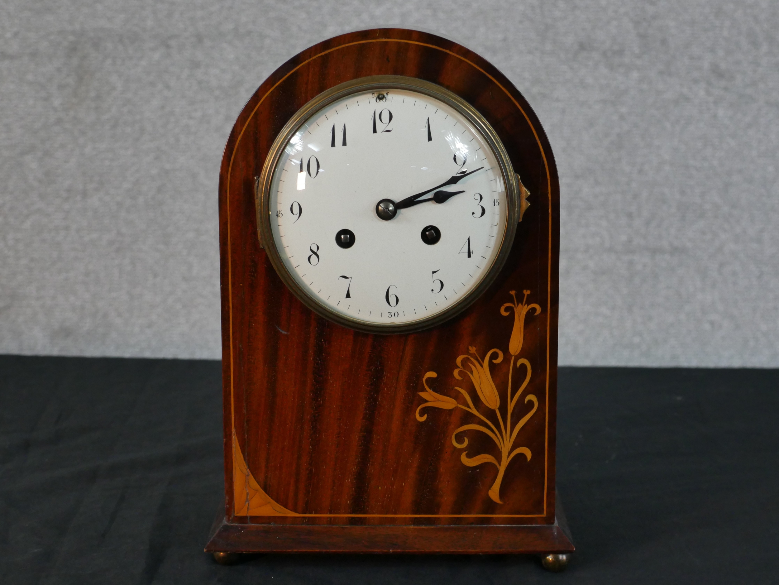 An Edwardian inlaid mahogany dome topped mantle clock, white enamel dial with black painted Arabic