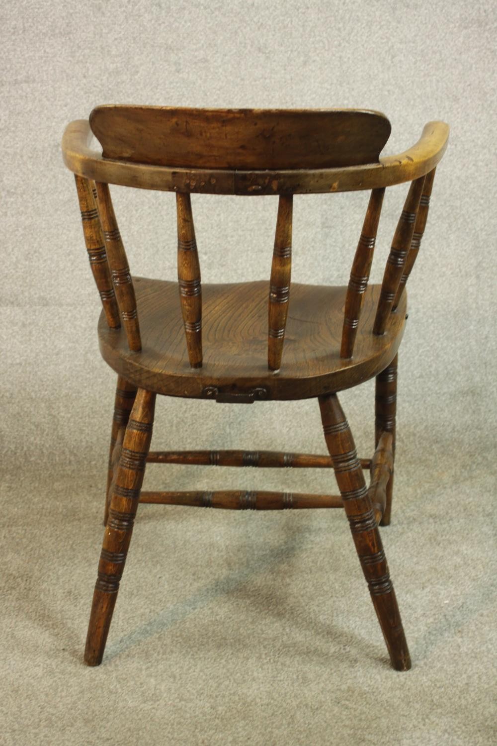 A 19th century captain's tub chair, the back on ring turned spindles, over an elm seat, on ring - Image 5 of 5