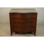 A George III mahogany serpentine bachelors chest, with a later gallery back and top over a