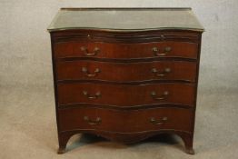 A George III mahogany serpentine bachelors chest, with a later gallery back and top over a