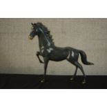 A patinated brass figure of a horse. H.46 W.52 D.10cm.