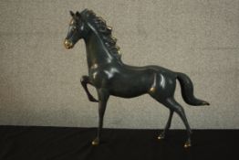 A patinated brass figure of a horse. H.46 W.52 D.10cm.