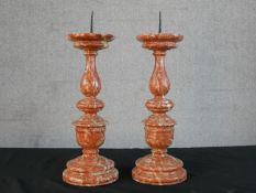 A pair of turned red marble pricket candlesticks. H.46 Diam.18cm