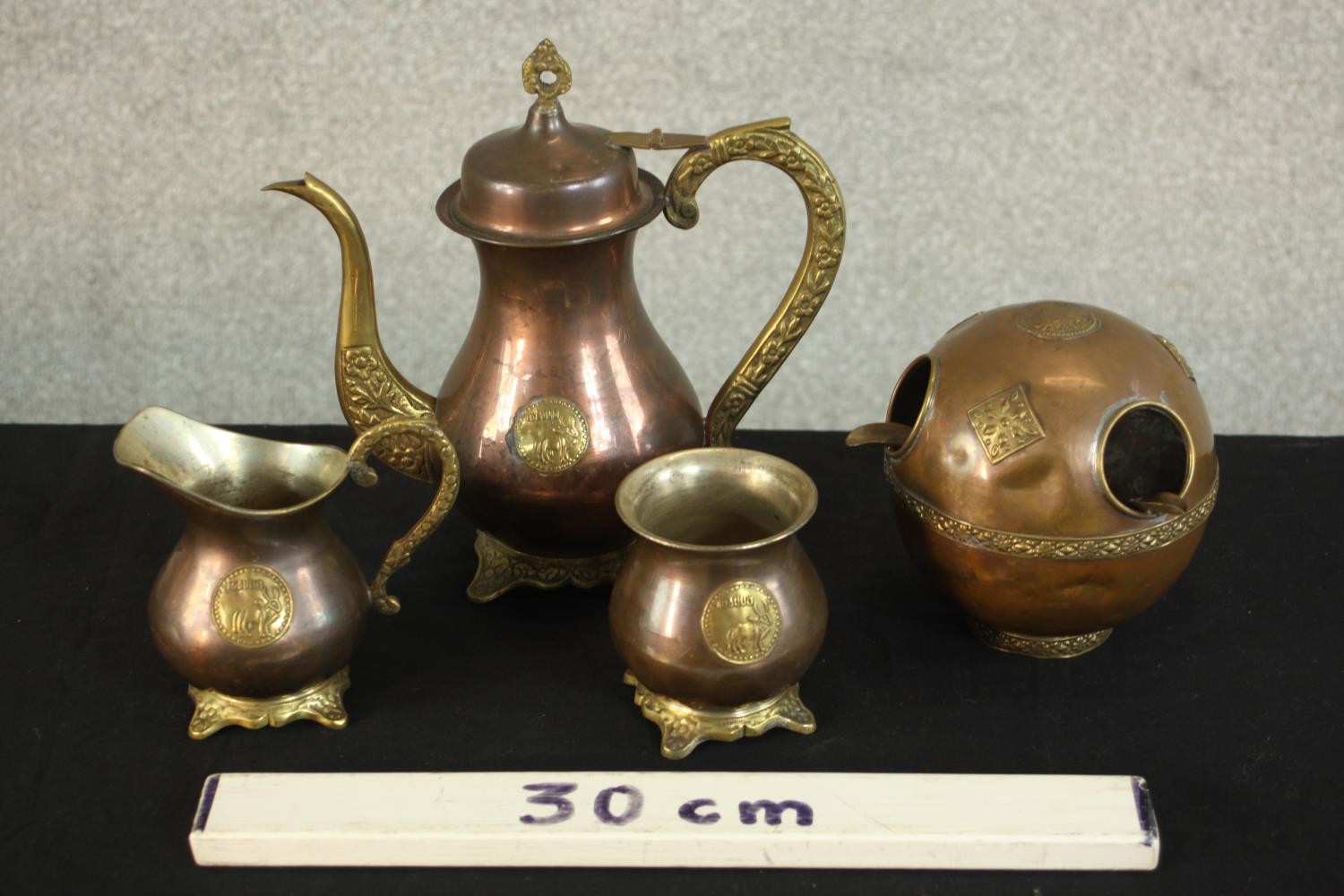 A three piece Indian brass and copper tea set with matching ashtray with relief lion boss detailing. - Image 2 of 12