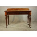 A Victorian walnut side table, with a gallery back over two short drawers with knob handles, on