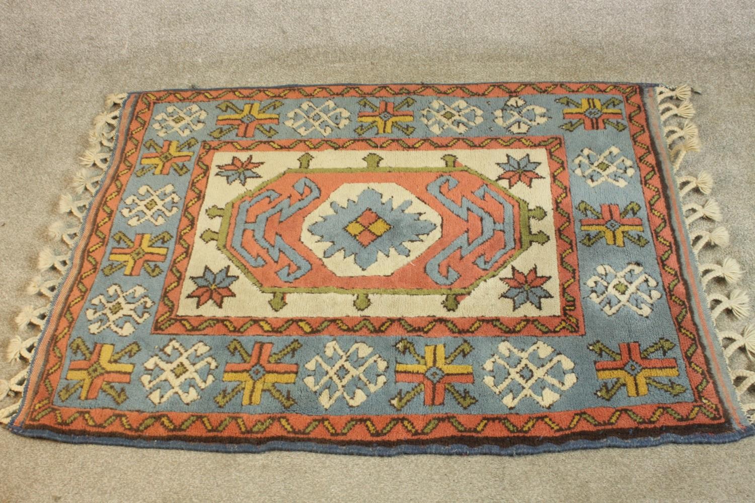 A hand made cream ground Konya rug. L.140 W.102cm.