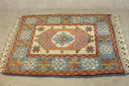 A hand made cream ground Konya rug. L.140 W.102cm.