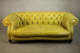 A yellow leather Chesterfield two seater sofa by Baxter - Italy, with