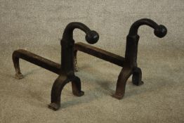 A pair of wrought iron fire dogs. H.40 W.23 D.53cm. (each)
