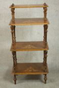 An Edwardian marquetry inlaid walnut whatnot of four tiers on turned and fluted supports. H.116 W.54