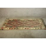 A hand made Turkish Kelim rug. H.193 W.107cm.