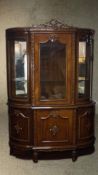 A late 20th century Louis XV style lacquered beech display cabinet, with a carved ribbon cresting