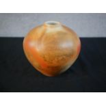Chris Yardley, an orange glazed art pottery vase of bulbous form, signed to base. H.17cm