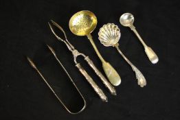 A collection of silver and white silver plate cutlery, including a Russian gilded silver floral