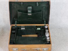 A vintage tan leather Drew & Sons of Piccadilly traveling vanity set. Dark green leather interior