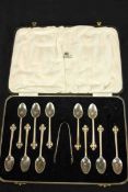 A leather cased set of silver teaspoons and tongs with engraved Celtic cross finials and plaited
