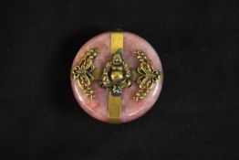 A 19th century early 20th century Chinese pink hardstone circular disc decorated on each side with
