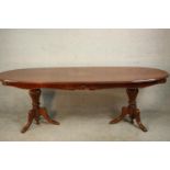 A late 20th century marquetry inlaid dining table, possibly Italian, with an ovoid top centred by