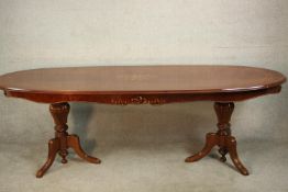 A late 20th century marquetry inlaid dining table, possibly Italian, with an ovoid top centred by