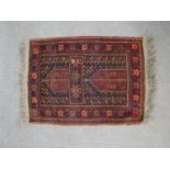 A red ground hand made Herat Belouch rug. W.68 D.53cm