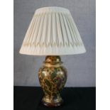 An Oriental printed and gilded stylised foliate design ceramic urn table lamp with pleated silk