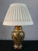 An Oriental printed and gilded stylised foliate design ceramic urn table lamp with pleated silk