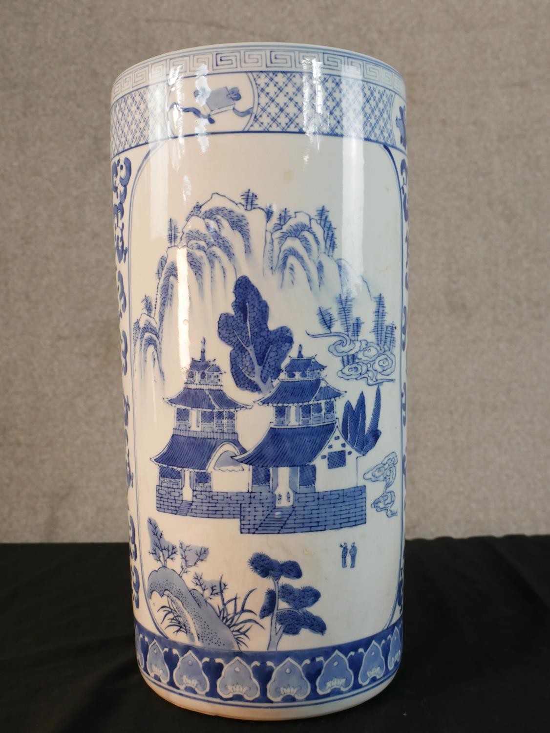 A late 20th century Chinese blue and white porcelain umbrella stand, of cylindrical form decorated