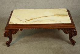 A late 20th century carved hardwood coffee table, with a rectangular onyx top and a gadrooned