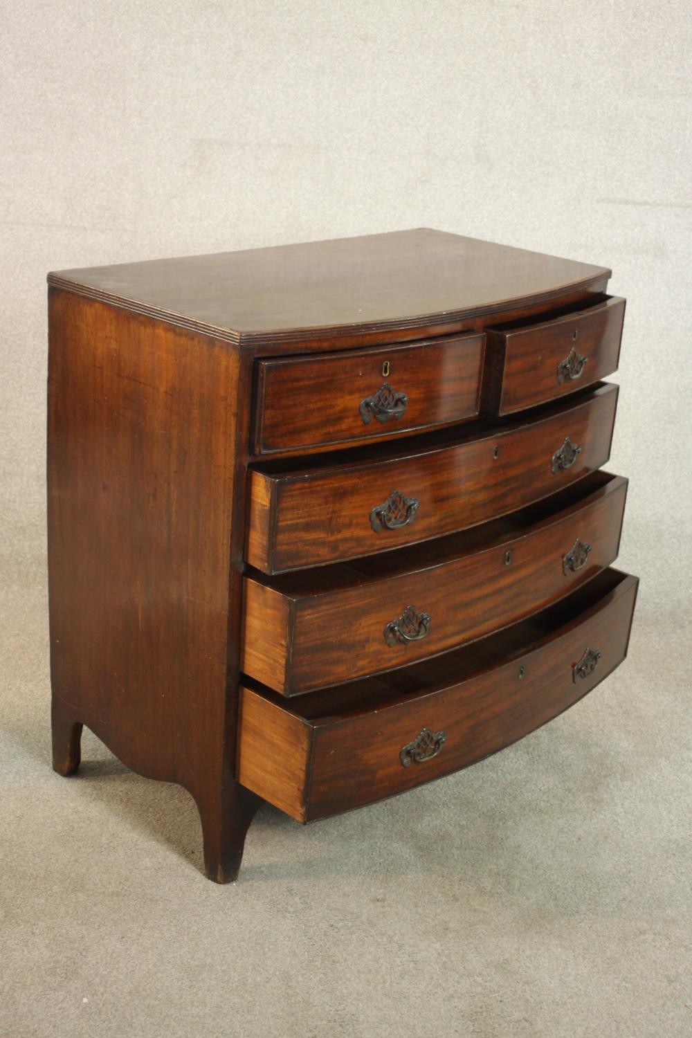 A George III bowfronted mahogany chest of two short over three long drawers above a shaped apron and - Image 5 of 8