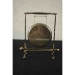 A silver plate table gong on stand with beater. H.19 W.19 D.8cm.
