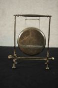 A silver plate table gong on stand with beater. H.19 W.19 D.8cm.