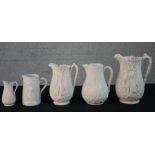 Five 19th century bisque porcelain relief design jugs, two with a game animal design, maker's