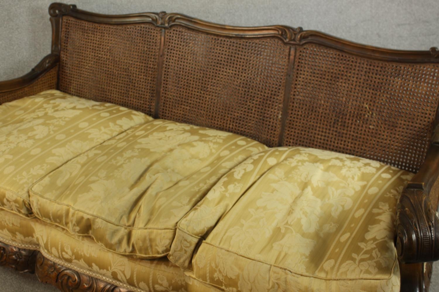 An early 20th century Continental carved walnut three seater bergere sofa, upholstered in gold - Image 11 of 18