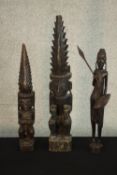 Three early 20th century carved African tribal figures, one of a figure with a spear. H.59 W.10 D.