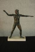 An ancient Greek style patinated spelter figure of Artemision on marble base. H.43 W.41 D.10cm.